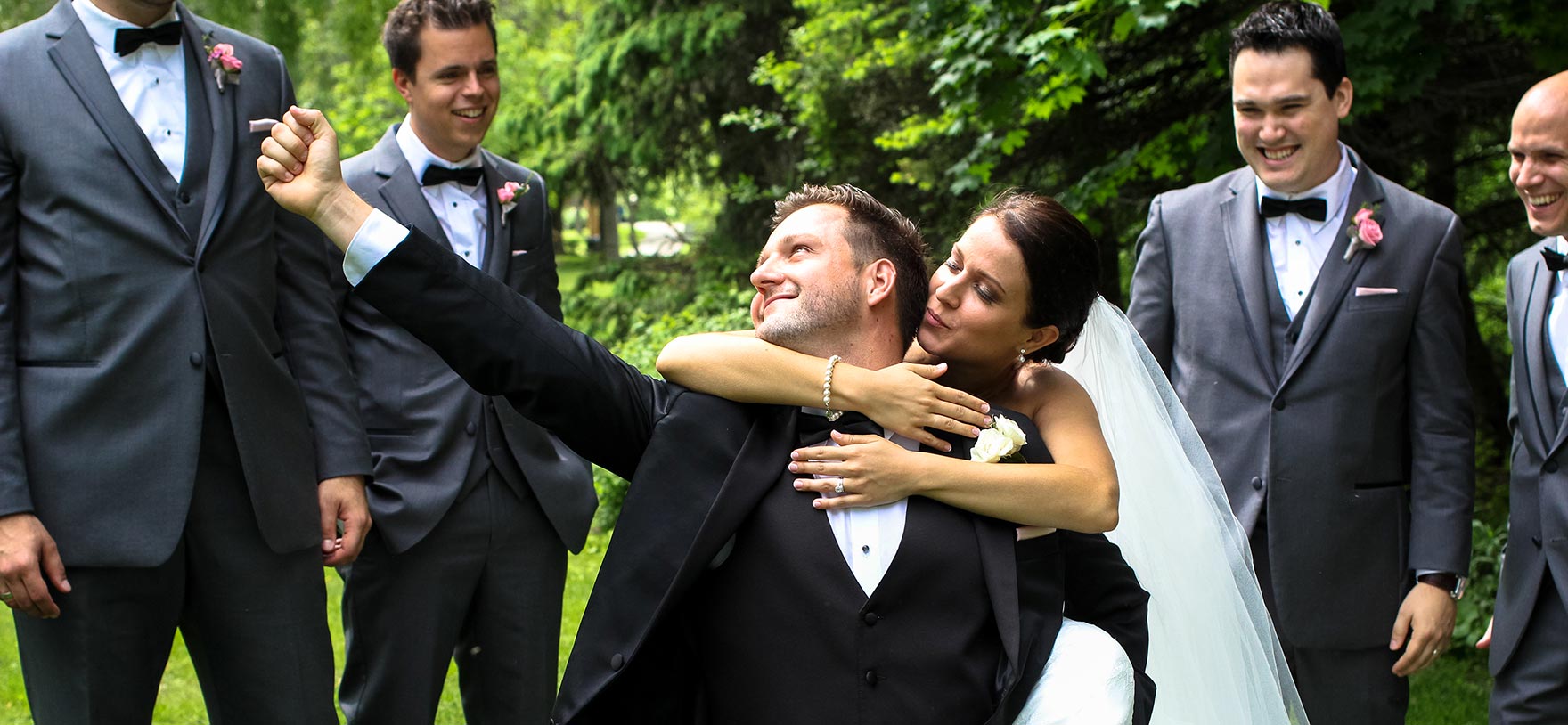 Image of groom pumping his fist with groomsmen & bride for Quotacy blog The Wedding Gift Every Couple Should Give Each Other.
