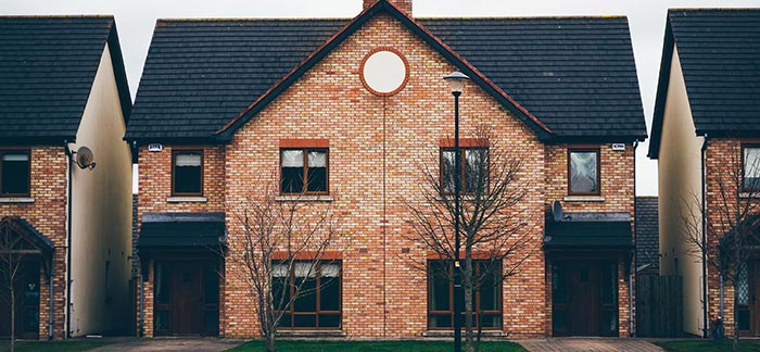 Image of brick row houses for Quotacy blog Term Life Insurance for Homeowners.