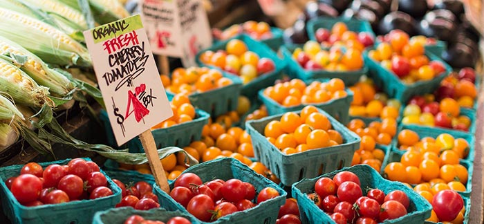 Image of cartons of cherry tomatoes for sale in a farmers market