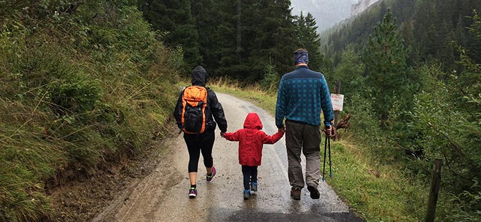 Image of young family hiking down a mountain path for Quotacy blog Your Changing Life Insurance Needs.