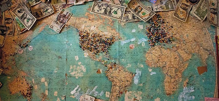 Image of world map with pins marking countries where travelers are from for Quotacy blog Foreign Travel and Life Insurance.