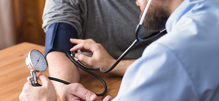 Image of a man getting his blood pressure read for Quotacy blog Life Insurance and Hypertension: Buyer's Guide