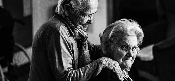 Image of elderly woman kindly touching shoulders of another elderly woman for Quotacy blog Plan for the Future – Alzheimer’s.