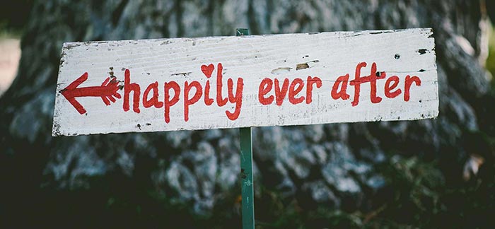 Image of handmade sign in the ground that says happily ever after for Quotacy blog Love and Marriage and Life Insurance.