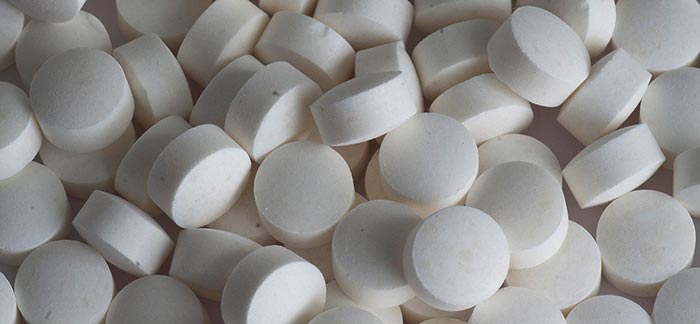 Image of a bunch of white pills for Quotacy blog Life Insurance Riders for Retirement: Long-Term Care and Chronic Illness
