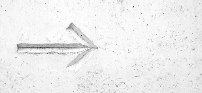 Image of arrow carved into a concrete wall for Quotacy blog Why Do Premiums Increase at the End of a Term Policy?