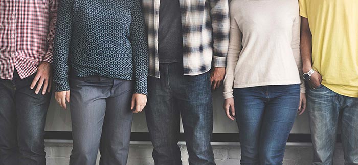 Image of people standing against a wall for Quotacy blog Do I Need Individual Life Insurance if I Have Group Life Insurance?