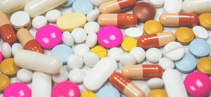 Image of many different pills scattered on a table