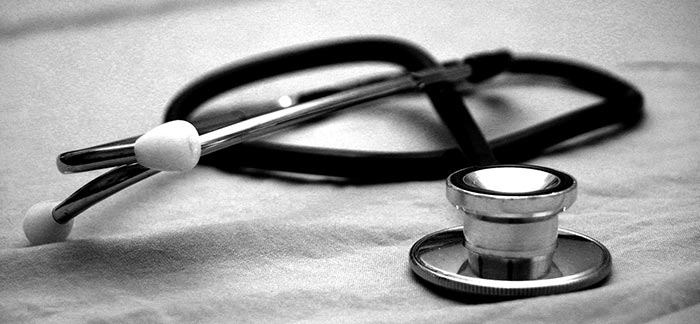 Image of stethoscope on bed for Quotacy blog Life Insurance and Hepatitis: Buyer's Guide