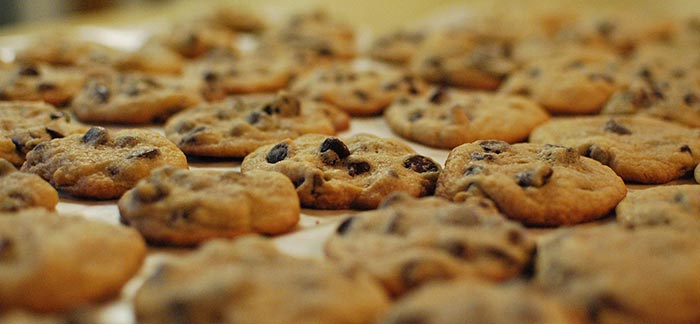 Image of tray of fresh baked chocolate chip cookies for Quotacy blog Why Do We Love Unhealthy Food?
