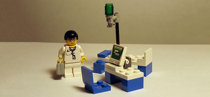 Image of Lego medical doctor in Lego exam room for Quotacy blog What Is the Medical Information Bureau?