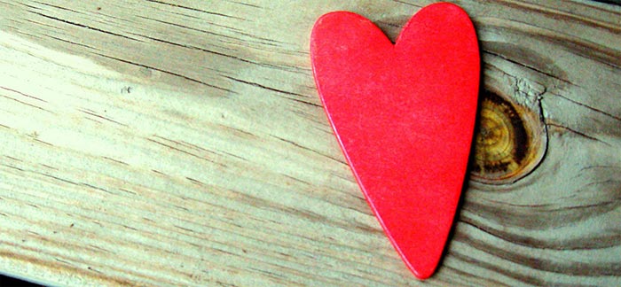 Image of red heart on wood plank for Quotacy blog National Donor Day.