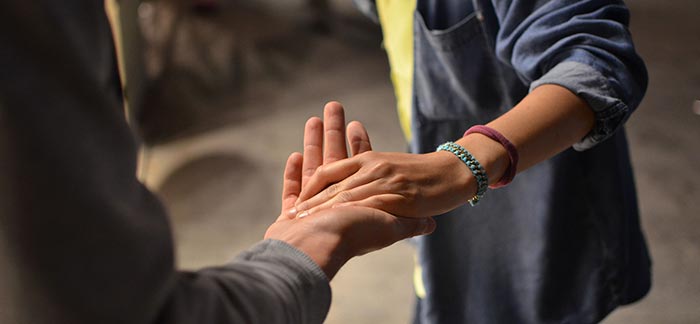 Image of person reaching out hand offering support to another person for Quotacy blog Substance Abuse and Life Insurance.