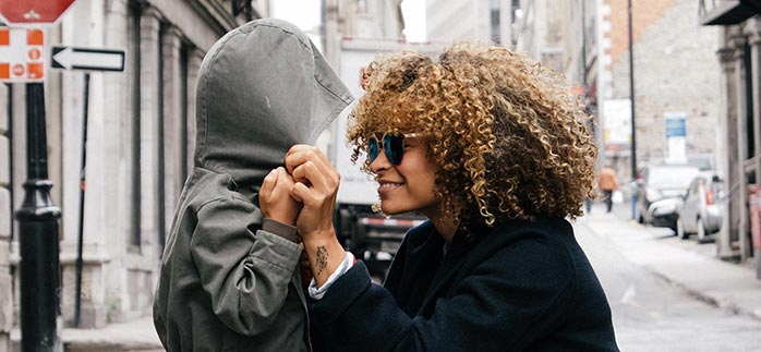 Image of mom & child looking at each other on a city street for Quotacy blog Millennials Shouldn’t Wait to Buy Life Insurance