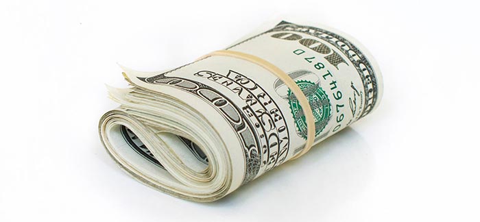 Image of rolled up cash bound with rubber band for Quotacy blog What Is a Life Insurance Premium?