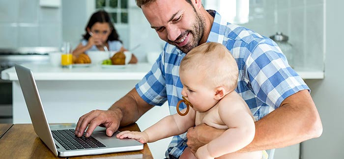Image of father holding baby for Quotacy blog: A Guide to Life Insurance for Freelancers.
