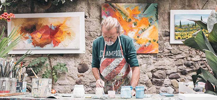 Image of senior man painting in a studio