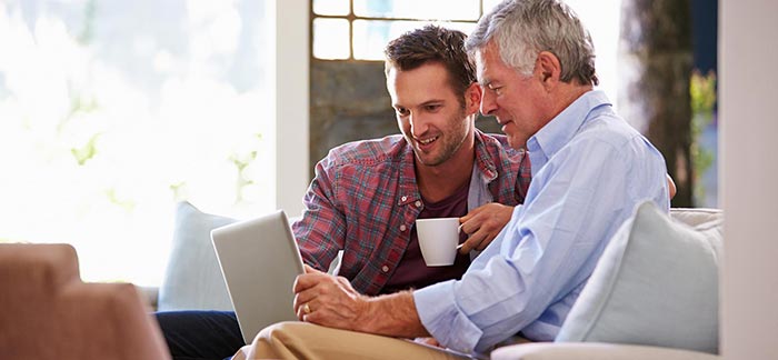 Image of adult son with senior father for Quotacy blog: Life Insurance for Parents: How To Help Your Parents Buy Life Insurance.