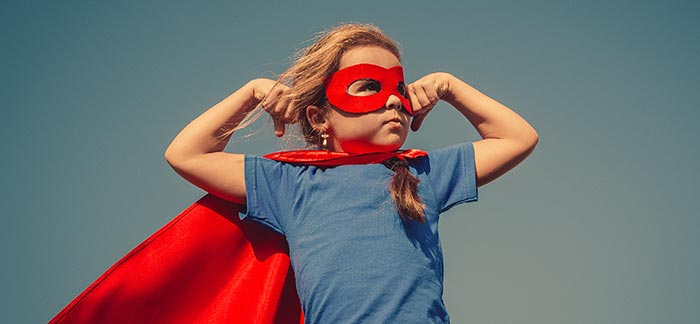 Image of a girl with a cape flexing her muscles