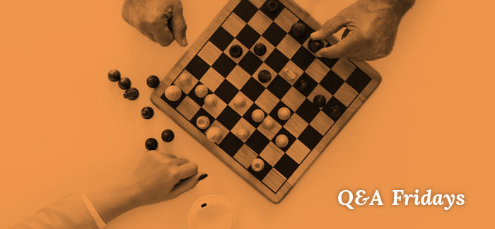 Image of two people playing chess for the Quotacy blog: What Factors Affect My Life Insurance Cost? | Q&A Fridays.