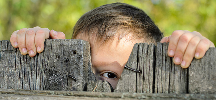 boy looking through fence for Quotacy february 2018 newsletter