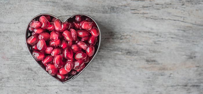 Image of a heart shaped bowl filled with pomegranate seeds for the Quotacy blog: Can I Save Money on Life Insurance if I Lose Weight?
