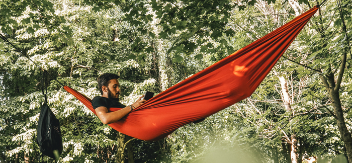 Image of a man in a hammock, free of financial stress