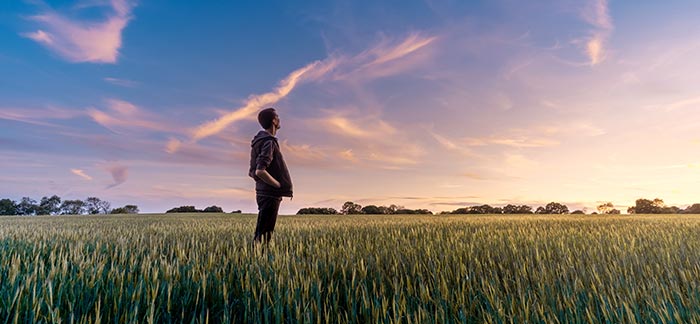 man thinking in a field for Quotacy blog Ready to think about life insurance again