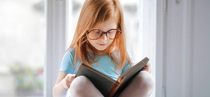 young girl reading for Quotacy blog Life Insurance Helps Provide for the Basics and Beyond