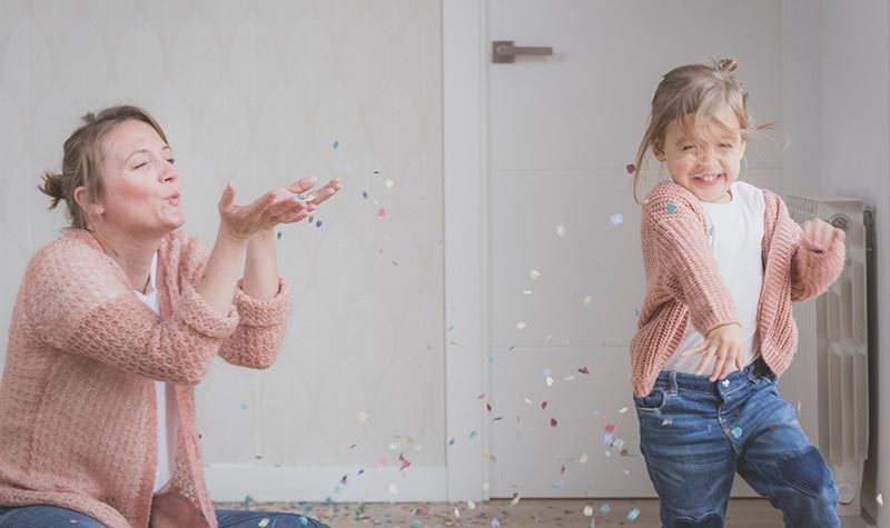 life_insurance_for_children_3 Mom and daughter playing with glitter and laughing.