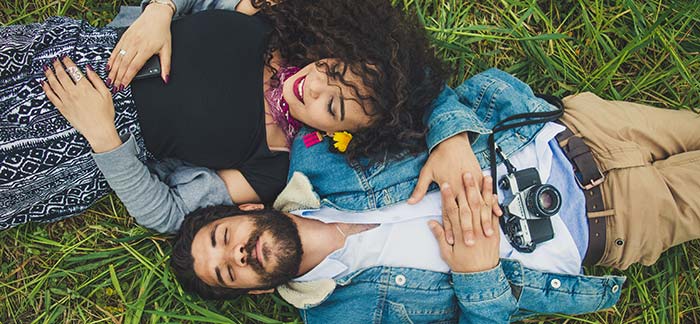 young couple in the grass for Quotacy blog Am I too young to buy life insurance