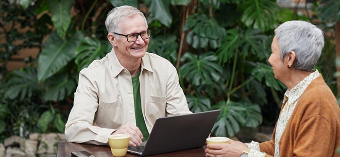 elderly man on laptop for Quotacy blog helping parents with finances