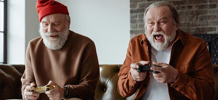 two elderly men playing video games for Quotacy blog how men can increase longevity