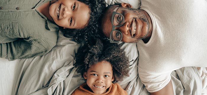 Black father with two daughters for Quotacy blog how do I qualify for life insurance