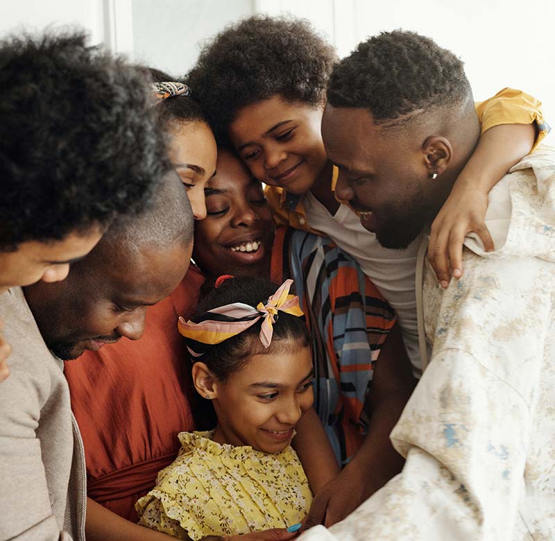 what_is_term_life_insurance_lp_2 Large family hugging in the kitchen.