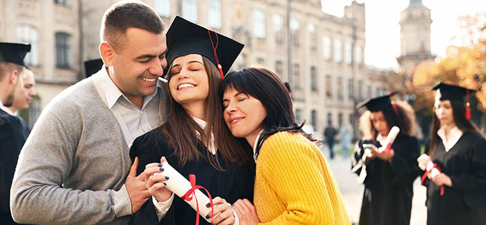 Latino family with daughter at graduation for Quotacy blog important things to do when child turns 18