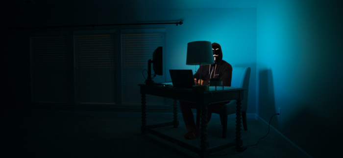 hacker in a dark room for Quotacy blog protection from cyberattacks