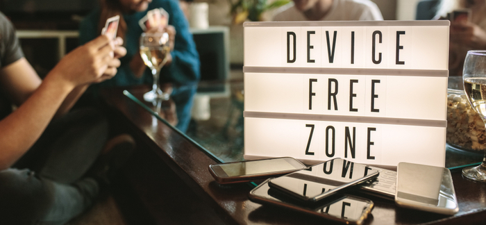 sign that says device free zone for Quotacy blog guide to digital detoxing
