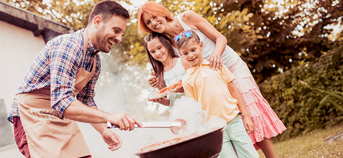 family grilling together for Quotacy blog about life insurance process taking time