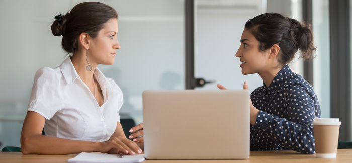 two women talking at work