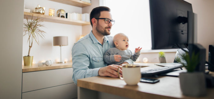 dad holding baby son in lap for Quotacy blog Should I Buy Term Life Insurance