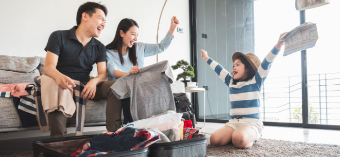 Asian family packing for vacation