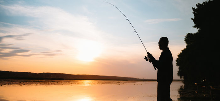 man fishing against the sunset